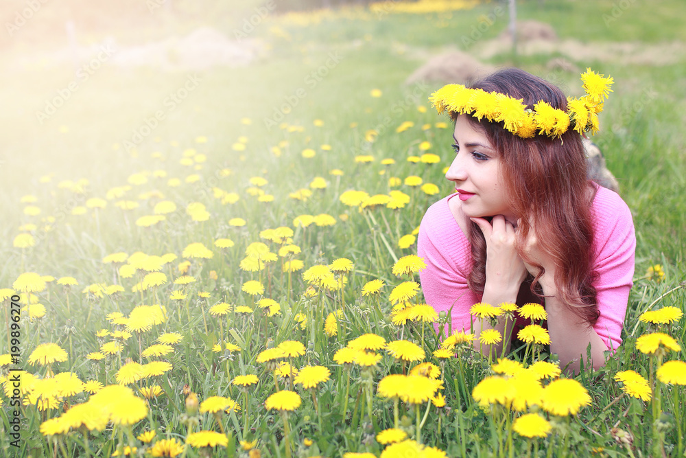 girl resting on a sunny day in meadow of yellow dandelions girl resting on a sunny day in meadow of yellow dandelions