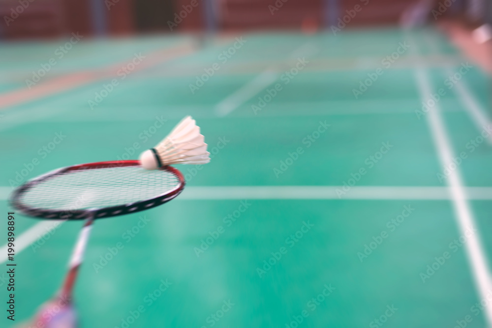 blurred badminton racket and shuttlecock in badminton court Stock