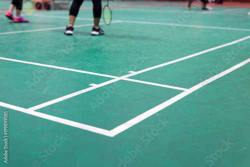 badminton court with player in game © ttanothai