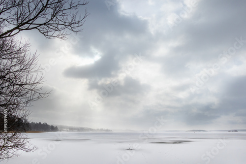 Beautiful winter seacape with hazy clouds and frozen sea.