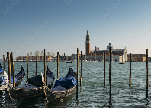 Gondolas moored by Saint Mark square with San Giorgio di Maggiore church in Venice, Italy with copy space © Alexandre Rotenberg