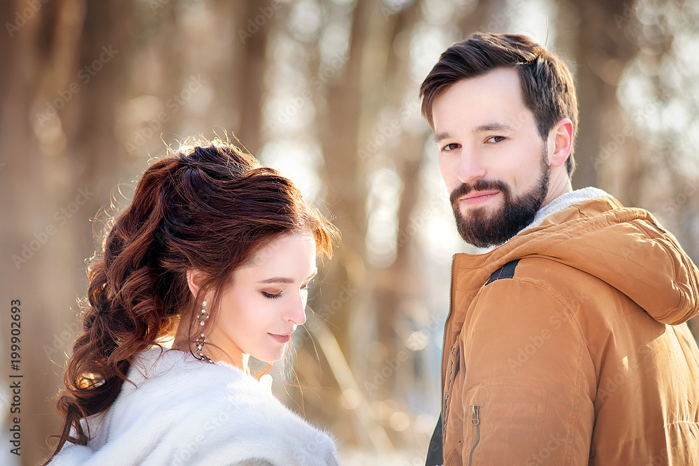 Portrait of a wedding couple on a winter sunny day. Portrait of a wedding couple on a winter sunny day.