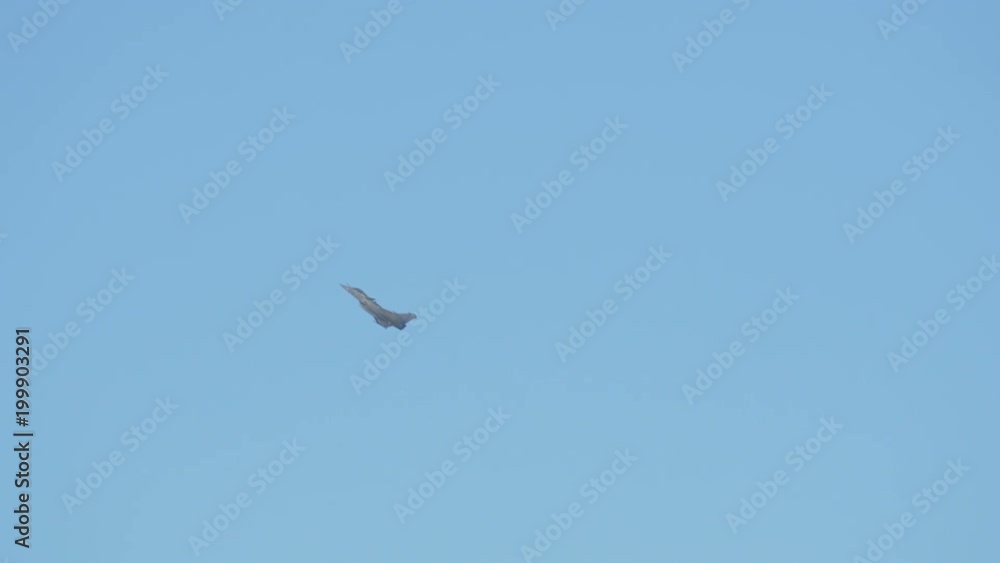 Jet plane flying and rotating on the sky Jet plane flying and rotating on the sky