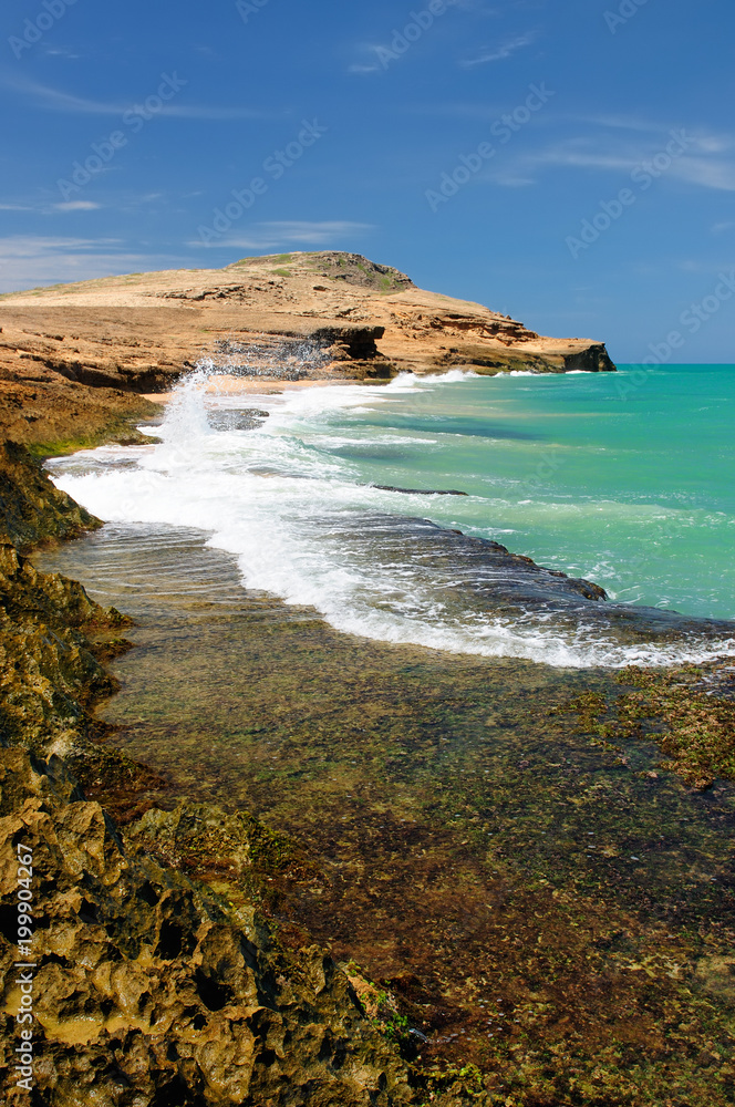 Colombia, wild coastal desert of Penisula la Guajira near  the Cabo de la Vela resort.  Pilon de Azucar beaches of the Caribbean coast with turquoise water and orange sand