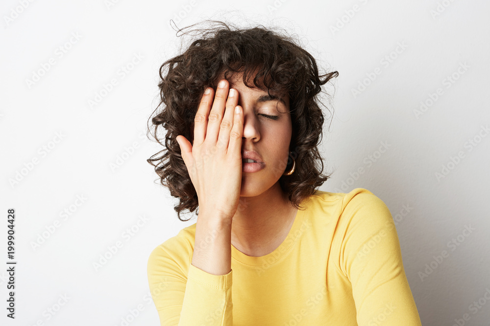 Close up portrait of a beautiful young woman with curly hair. White background. Relaxing concept. Close up portrait of a beautiful young woman with curly hair. White background. Relaxing concept.