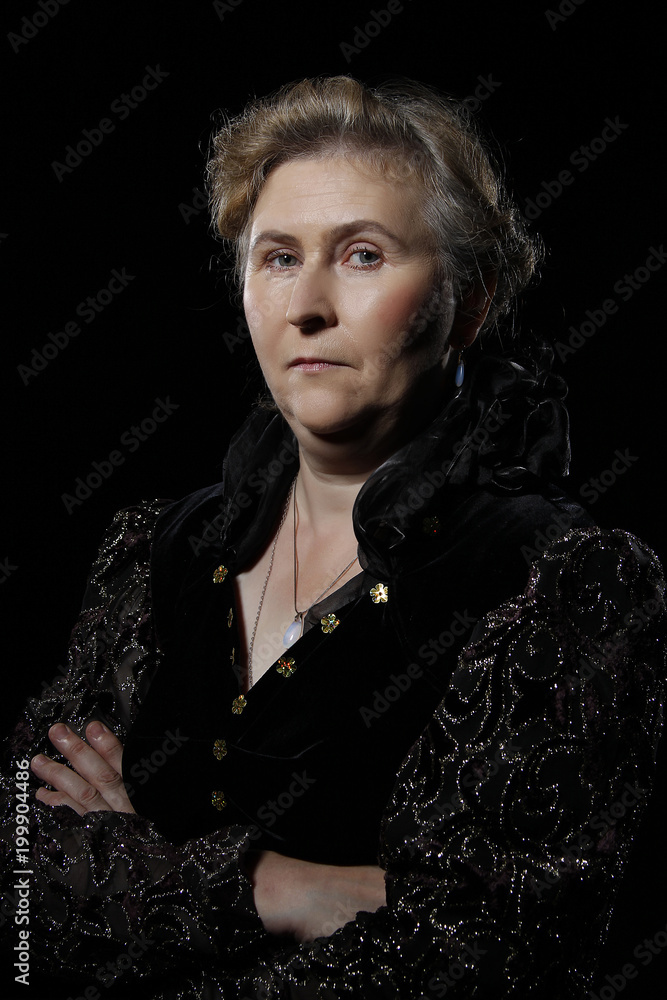 elderly woman on black background.Evil woman. An elderly woman with an evil face. Severe woman. A strict lady. elderly woman on black background.Evil woman. An elderly woman with an evil face. Severe woman. A strict lady.