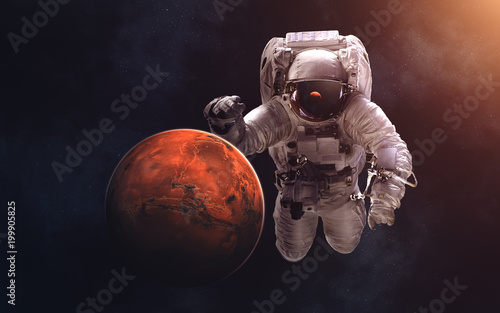 Fototapeta Naklejka Na Ścianę i Meble -  Mars and giant astronaut. Image in 5K resolution for desktop wallpaper. Elements of the image are furnished by NASA