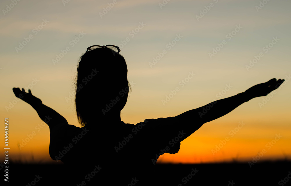 The silhouette of women is holding hands happily.