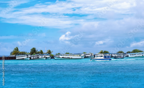 Boats moored at Male Harbor  Maldive island on a sunny blue cloudy sky