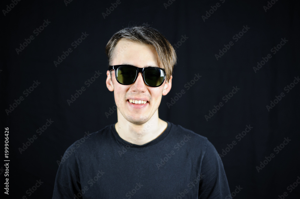 portrait of a young guy on a black background portrait of a young guy on a black background
