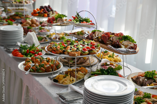 Catering service. Restaurant table with snacks food at event. photo