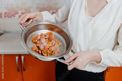 pieces of chicken meat in a shiny pan photo