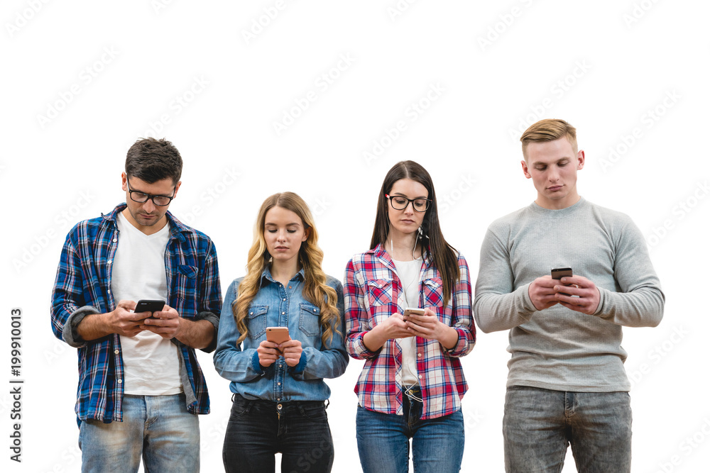 Obraz premium The four friends with phones stand on the white wall background
