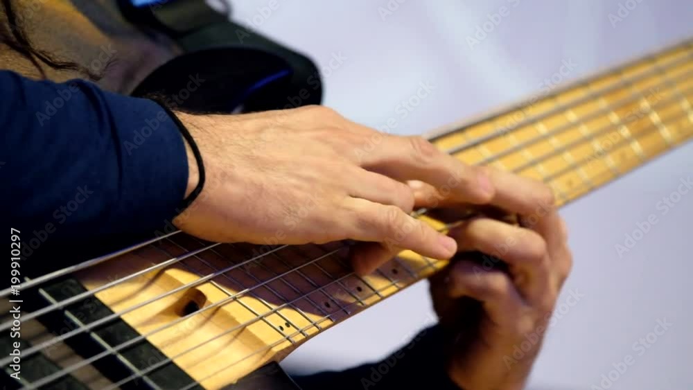Male hands playing guitar macro