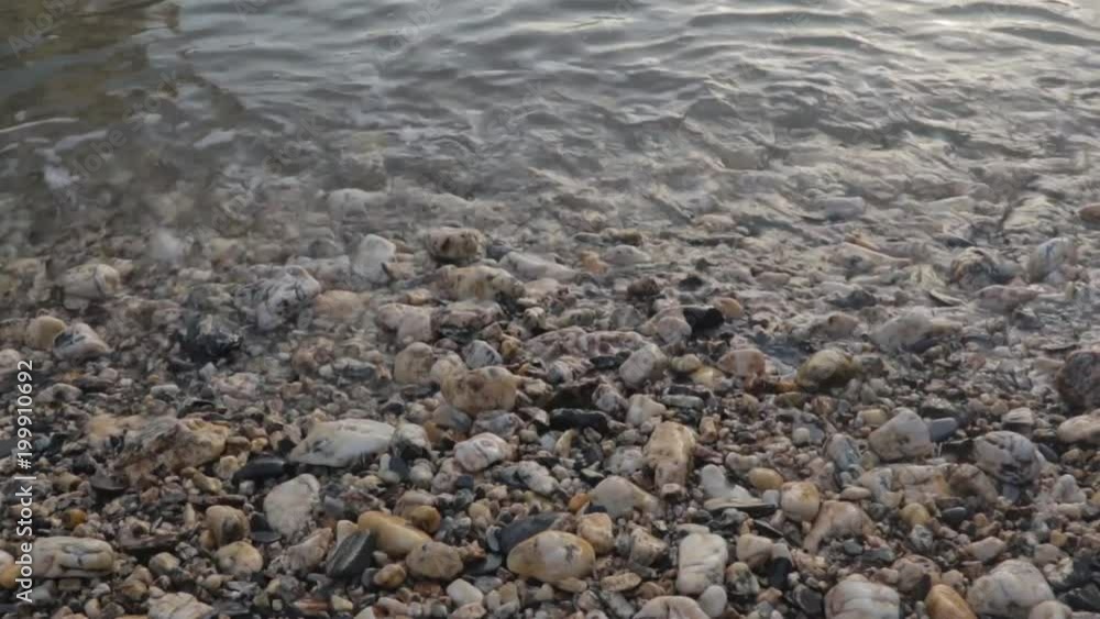 Waves calmly washing up rocky beach Waves calmly washing up rocky beach