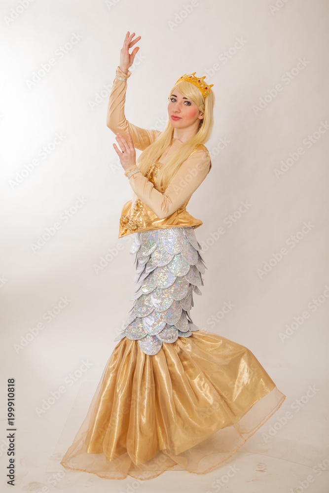 Fototapeta premium A young girl in a chic suit of a sea mermaid. Theatrical costume