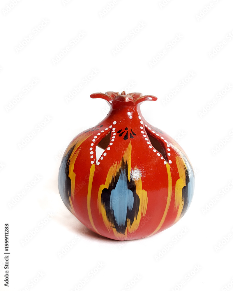 traditional Uzbek ceramicpomegranate with ornament Ikat on white background traditional Uzbek ceramicpomegranate with ornament Ikat on white background