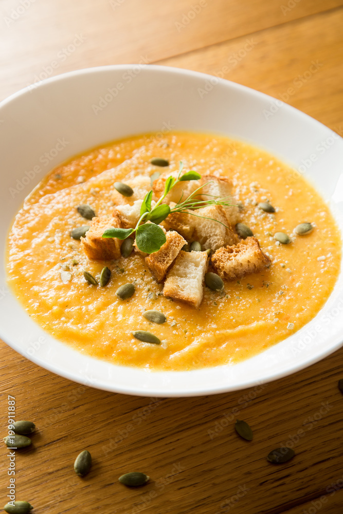 Pumpkin soup on wood table Pumpkin soup on wood table