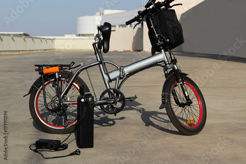 Fototapeta Naklejka Na Ścianę i Meble -  Electric bicycle with battery and charger