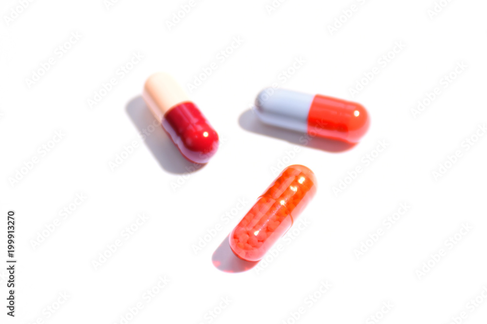 Different colorful  pills on white background