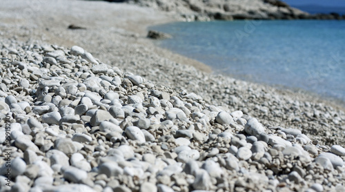 White pebbles beach and blue sea. Low angle view