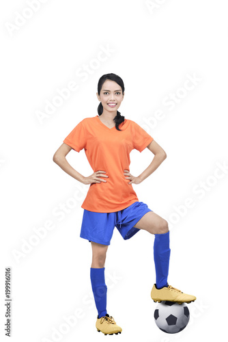 Image of asian football player with ball and hands on waist