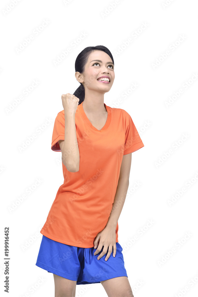 Beautiful asian football player woman in orange jersey with happy expression Beautiful asian football player woman in orange jersey with happy expression