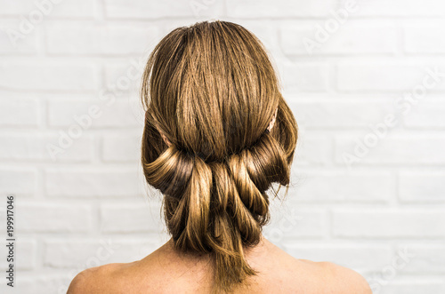 Head of a young woman from behind. Hairstyle in Greek style