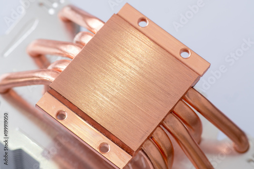 Aluminum radiator with copper heat pipe close-up with beautiful bokeh Concept of air cooling of the central processor of a computer photo