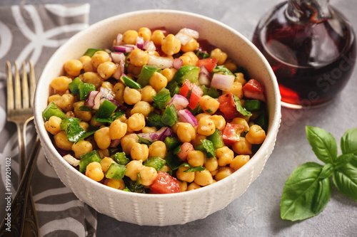 Chickpea salad with green pepper, red onion and vinaigrette dressing.