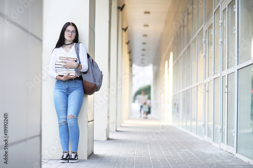 Girl student on the street with books