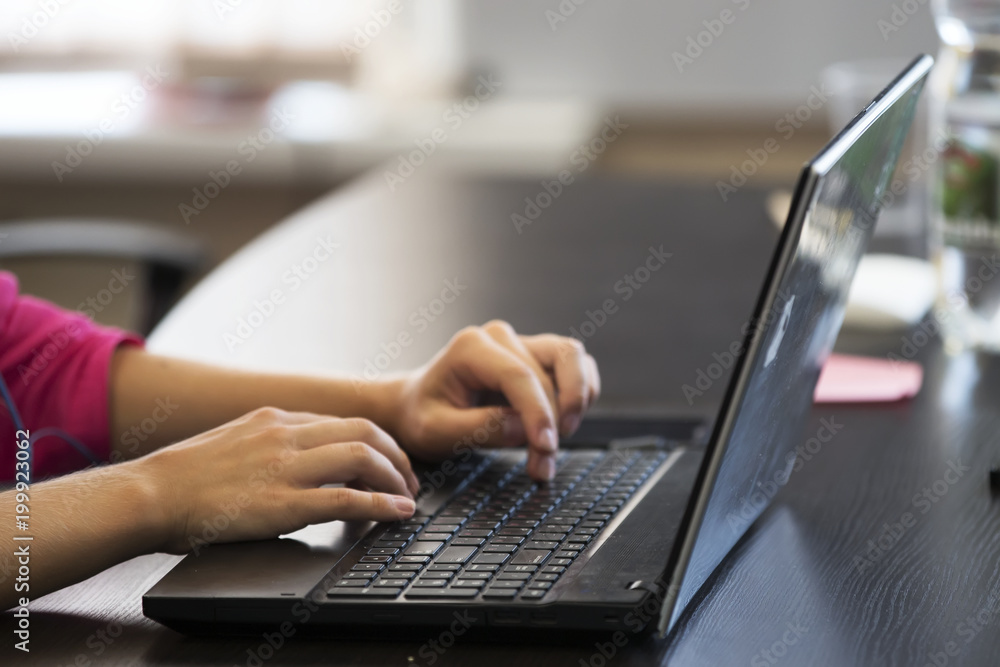 Print on laptop. Work at the computer. Work in the office at the computer. Hands on the keyboard Print on laptop. Work at the computer. Work in the office at the computer. Hands on the keyboard