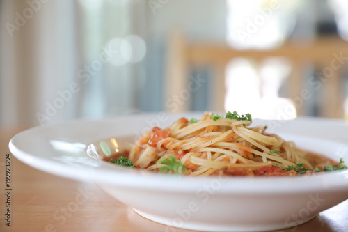spaghetti Bolognese with minced beef and tomato sauce garnished with parmesan cheese and basil , Italian food