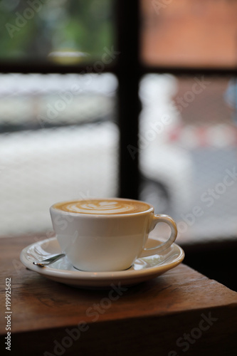 Cappuccino coffee cup on wood background