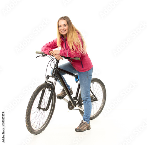 Girl in jeans on a bicycle on a white background.