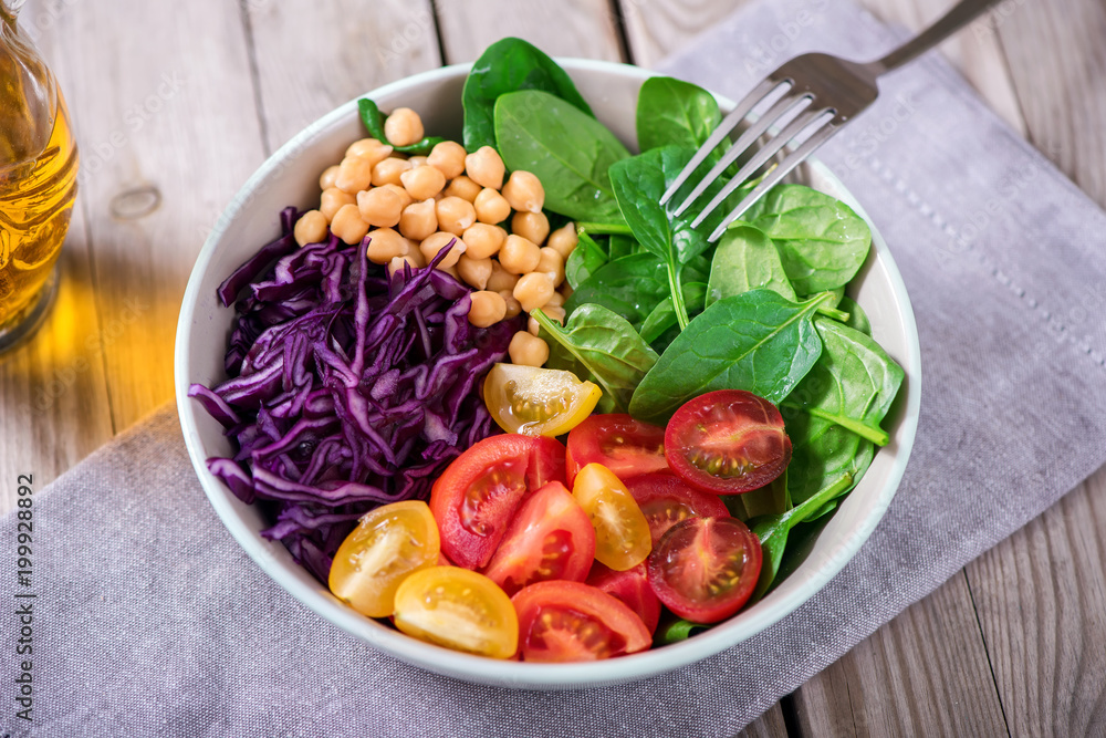Spinach salad bowl with chickpeas and veggies, healthy food, vegetarian and vegan snack, clean eating, diet, detox Spinach salad bowl with chickpeas and veggies, healthy food, vegetarian and vegan snack, clean eating, diet, detox