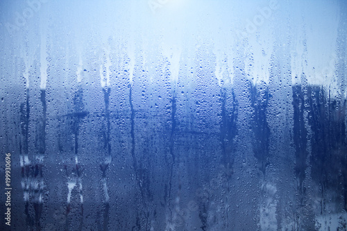 Rain drops on window glasses surface with sky cloudy background or texture grey frames abstract water of rainy day on black and white city at night silhouette Natural Pattern