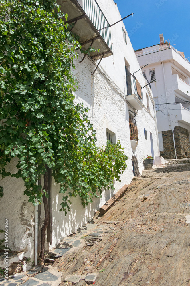 Traditional narrow street with white houses in historical center of city