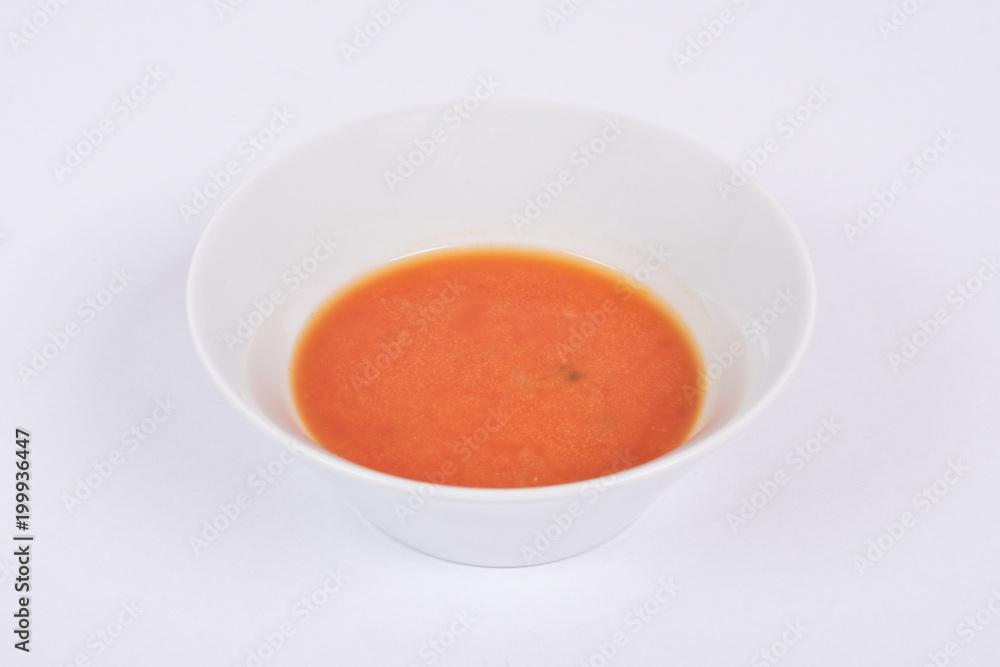 Tomato soup with milk on a white Tomato soup with milk on a white