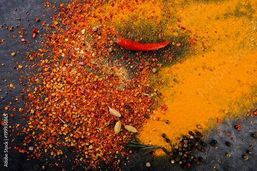 Spicy background with  mix of  spices  and peppers, masala close up on dark background. Top view.