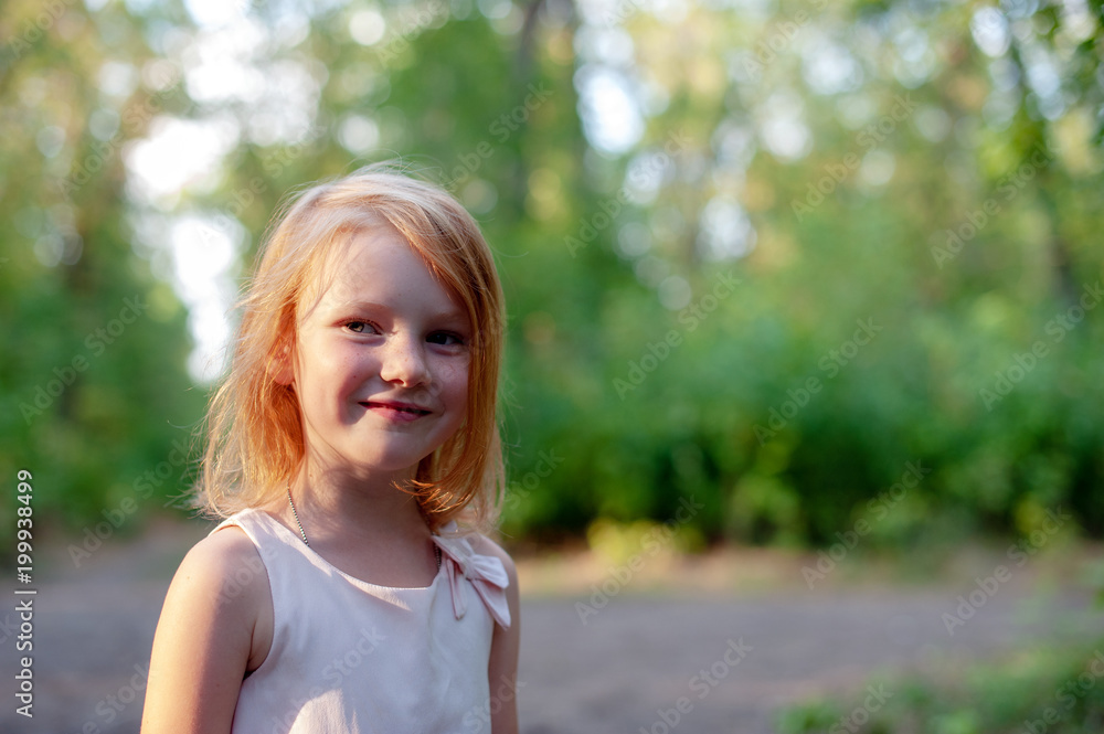 Smiling girl lit by the setting sun Smiling girl lit by the setting sun