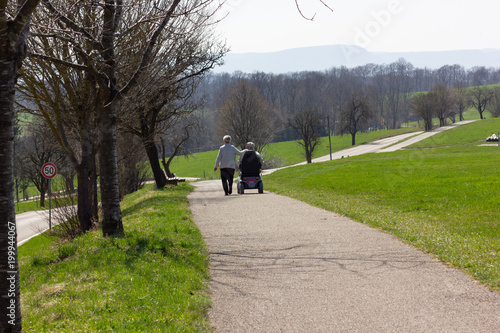senior couple with motordriven wheelchair photo