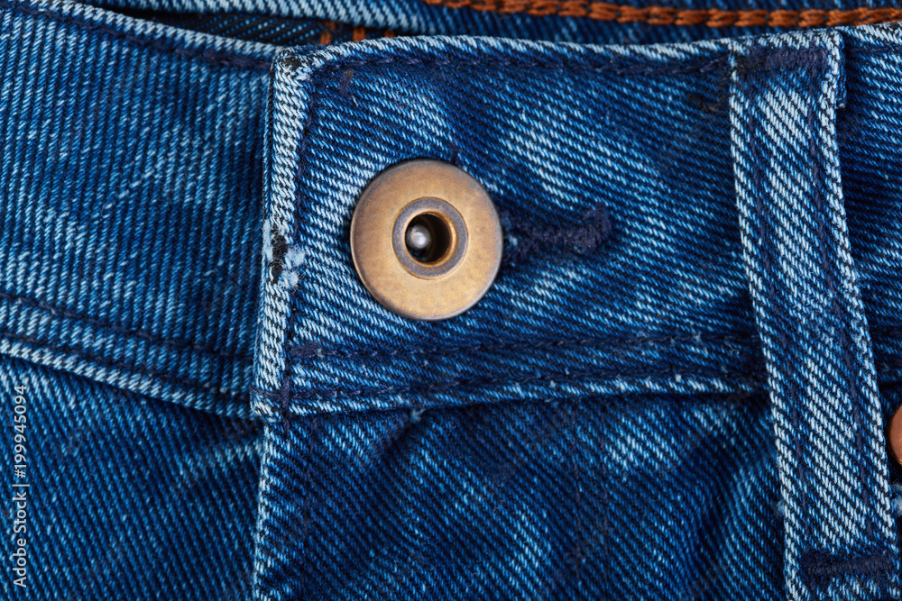 Denim jeans texture background with torn. The texture of the colored cotton fabric. Stitched texture jeans background. Fashion jeans button. Pocket and rivet on jeans. Fiber and fabric structure. Denim jeans texture background with torn. The texture of the colored cotton fabric. Stitched texture jeans background. Fashion jeans button. Pocket and rivet on jeans. Fiber and fabric structure.