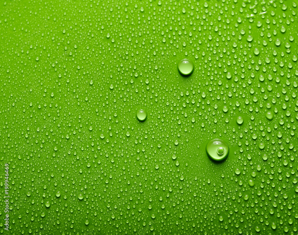 Small and large drops of water on a colored background. Abstract liquid sprays