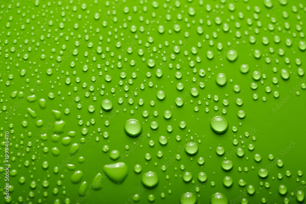 Small and large drops of water on a colored background. Abstract liquid sprays