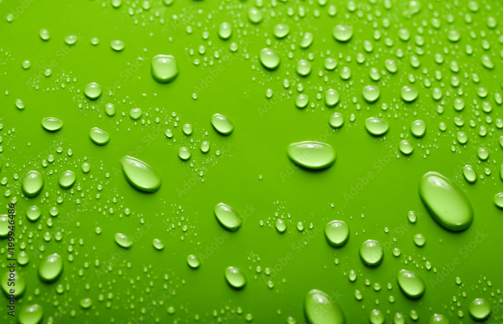 Small and large drops of water on a colored background. Abstract liquid sprays