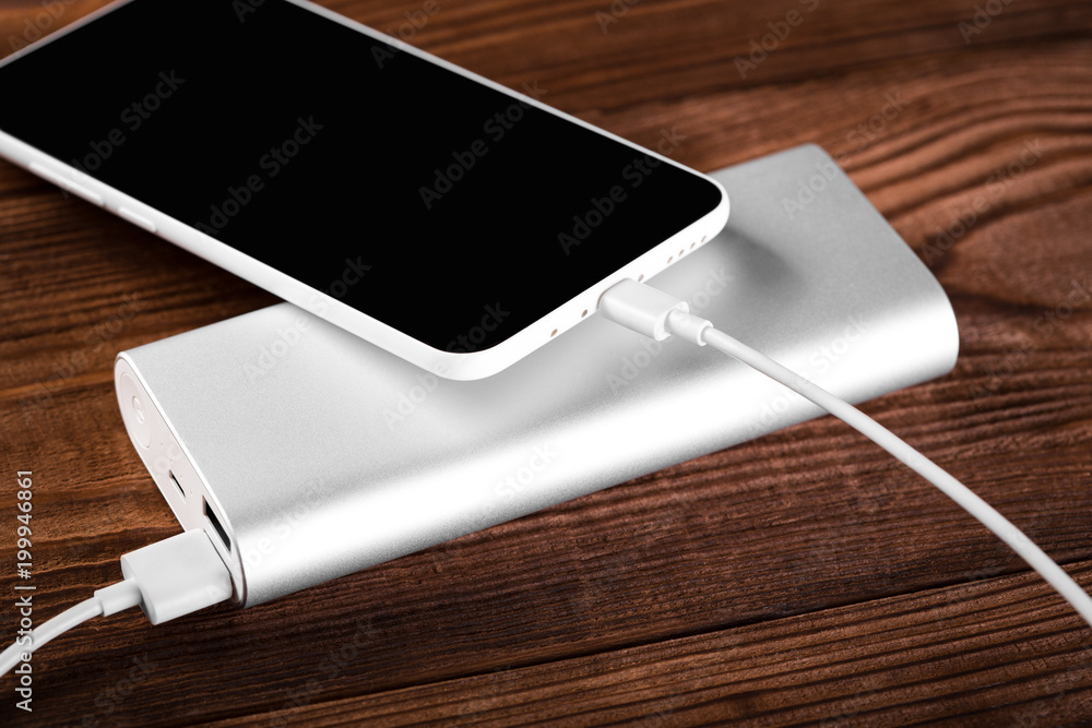 battery bank for charging mobile devices. Silver smart phone charger with power bank. External battery for mobile devices. battery bank for charging mobile devices. Silver smart phone charger with power bank. External battery for mobile devices.