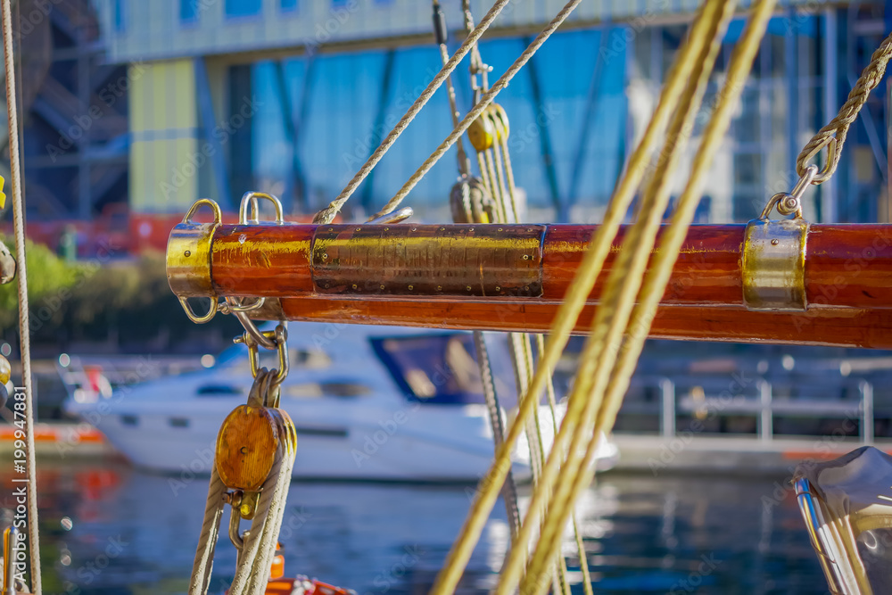 Close up of selective focus of ropes around mast support boom on boat in port of Alesund in Norway Close up of selective focus of ropes around mast support boom on boat in port of Alesund in Norway