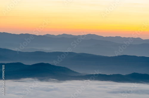 Sunset over mountains and fog