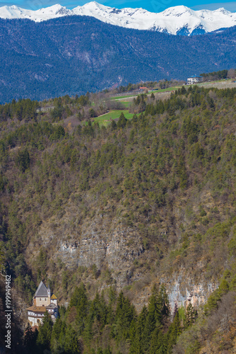 Picturesque view on the Sanctuary of San Romedio that is located on a steep rocky spur in the natural scenery of the Val di Non, Trentino, Italy photo